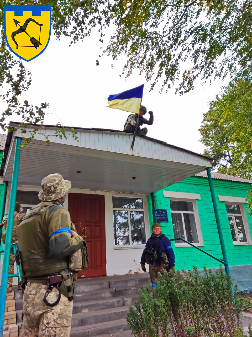 В освобожденном селе на Харьковщине бойцы теробороны устанавливают флаг Украины 
